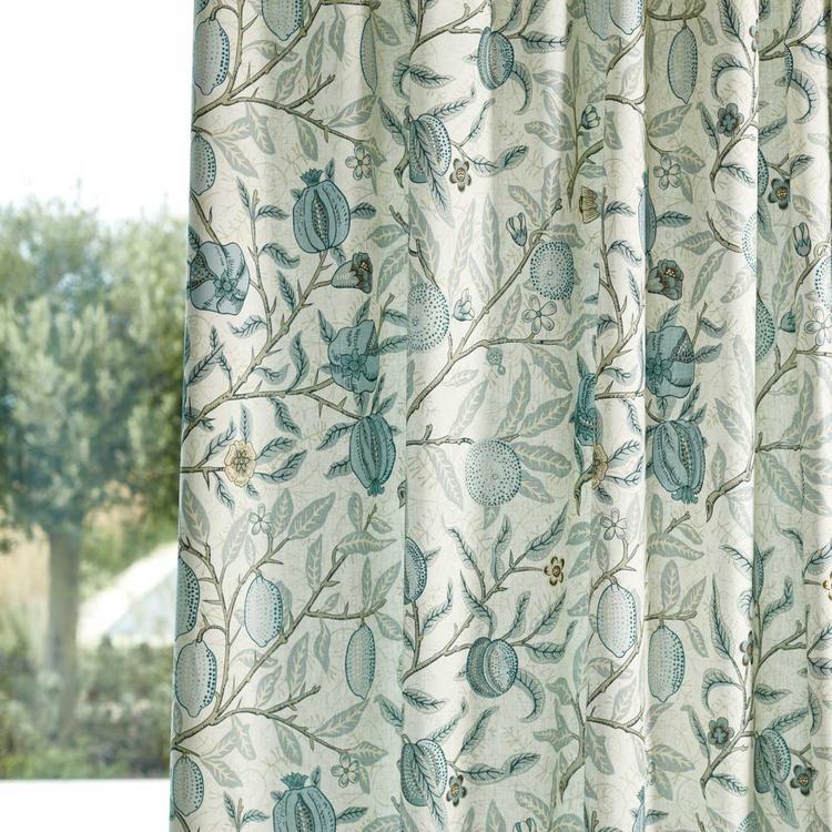 Morris & Co “Fruit” Wide-Width Fabric in Mineral Blue showing abundant pomegranates on branches, rich blue background in wide-width cotton-lyocell blend—perfect for curtains, blinds, cushions or upholstery.