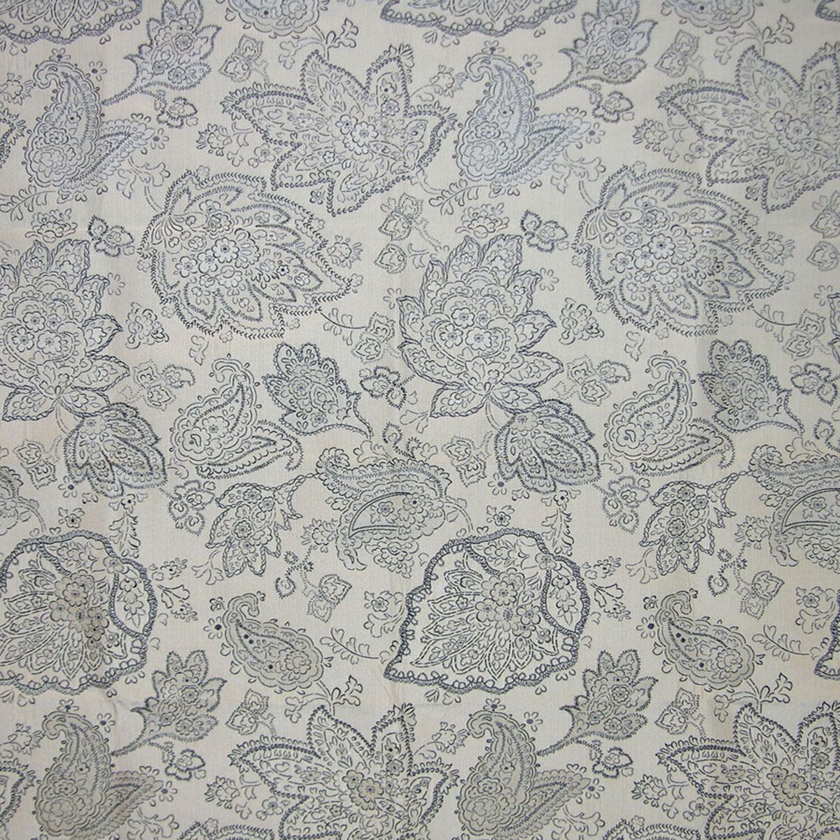 Charcoal fabric with intricate blue paisley and floral motifs; ornate textile for clothing or home decor.