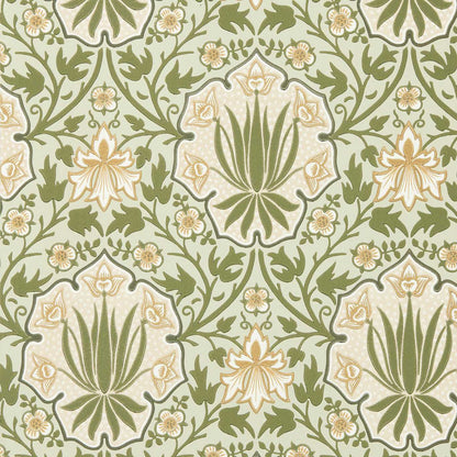Luxury botanical floral wallpaper featuring iris flowers, roses, shield motifs, and trailing vines in Bayleaf/Weld green and gold tones by Morris & Co. Vintage English cottage wallpaper ideal for Victorian interiors, maximalist homes, dining rooms, bedrooms, powder rooms, and elegant statement walls.