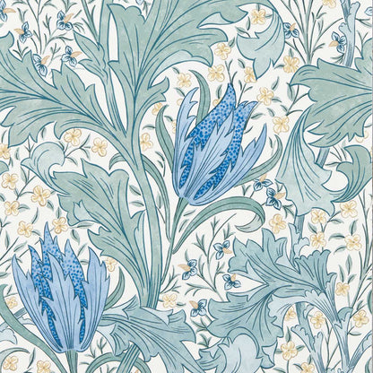 Morris & Co. Lent Lily Wallpaper in Cornflower Blue showcasing an intricate botanical pattern with oversized stylized tulips, delicate wild daffodils, and swirling acanthus leaves. This elegant floral wallpaper features a hand-drawn Arts & Crafts design inspired by William Morris, creating a sophisticated blue heritage wallcovering for bedrooms, living rooms, dining areas, libraries, and luxury interior spaces.