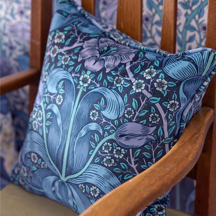 Morris & Co. Spring Thicket Velvet Fabric in Midnight/Lilac featuring flowing botanical foliage and elegant tulip flowers in deep midnight blue, soft lilac, and muted natural tones. Luxurious cotton velvet designer fabric ideal for drapes, window shades, upholstery, headboards, decorative pillows, cushions, and classic English-inspired interiors.