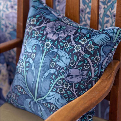 Morris & Co. Spring Thicket Velvet Fabric in Midnight/Lilac featuring flowing botanical foliage and elegant tulip flowers in deep midnight blue, soft lilac, and muted natural tones. Luxurious cotton velvet designer fabric ideal for drapes, window shades, upholstery, headboards, decorative pillows, cushions, and classic English-inspired interiors.