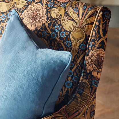 Morris & Co Spring Thicket velvet fabric in “Old Fashioned” colourway – rich rust and jewel‑toned large‑scale tulip and foliage design on cotton‑rich velvet, ideal for drapes, upholstery, headboards or cushions.