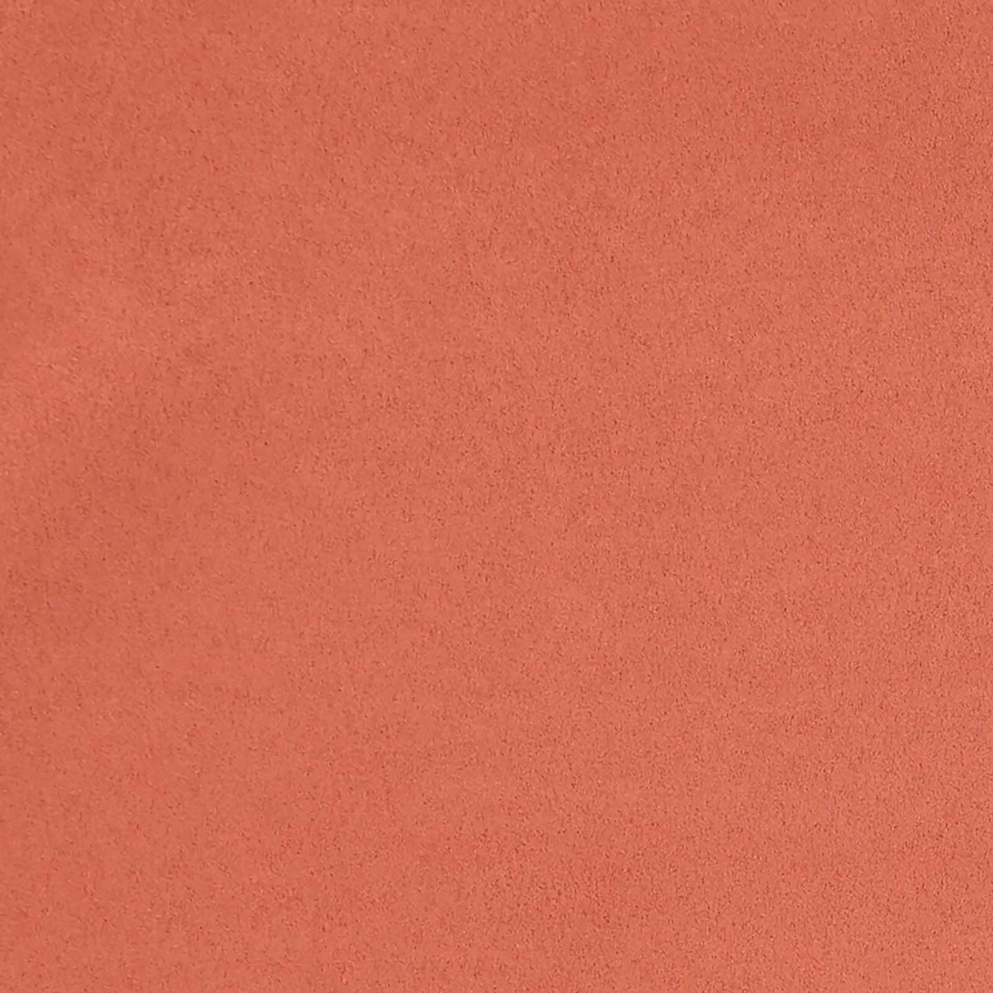 Close-up of orange suede-like fabric texture with a soft nap, ideal for upholstery or apparel.