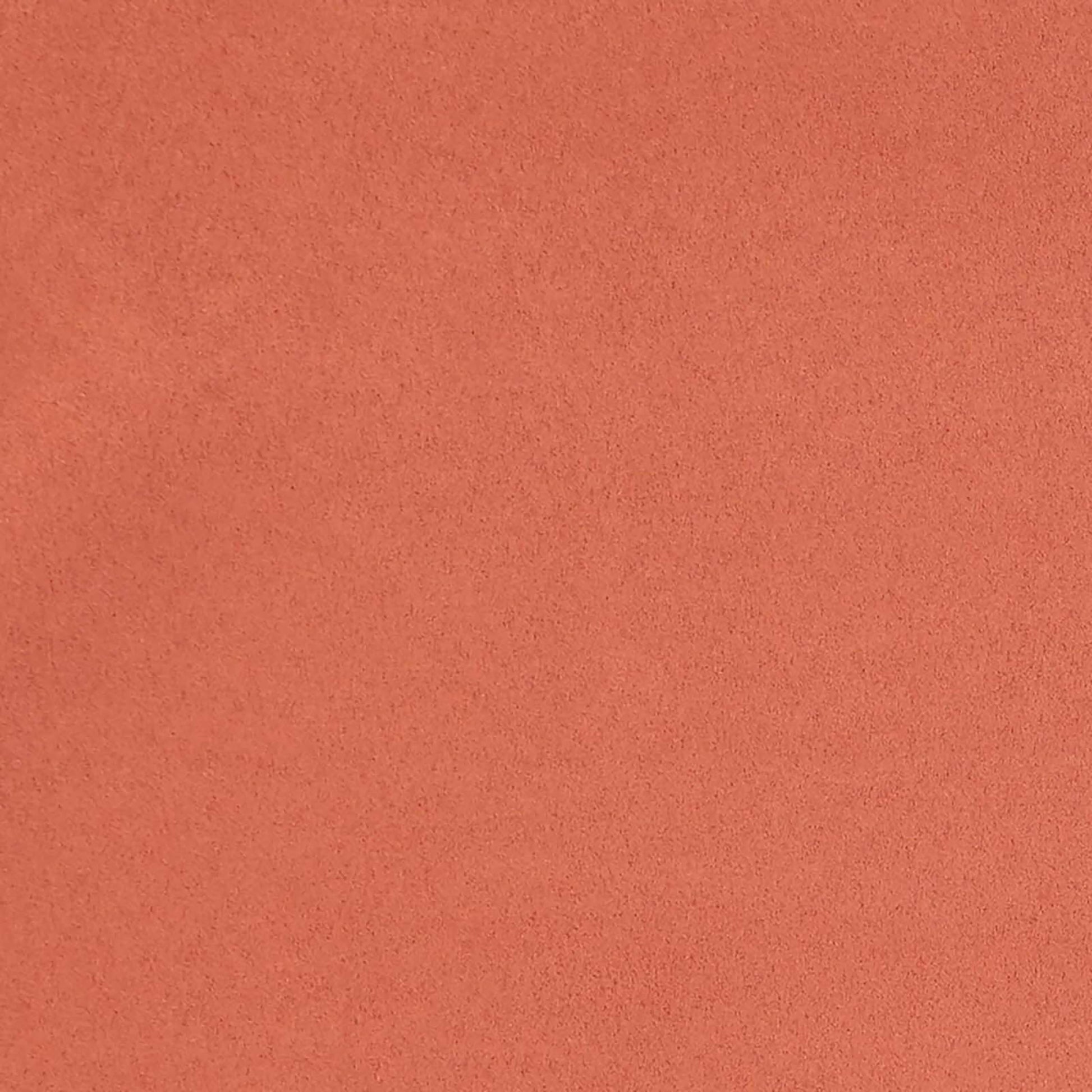 Close-up of orange suede-like fabric texture with a soft nap, ideal for upholstery or apparel.