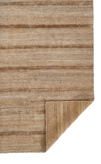 Natural brown striped rug with soft, textured pile; folded corner reveals underside.