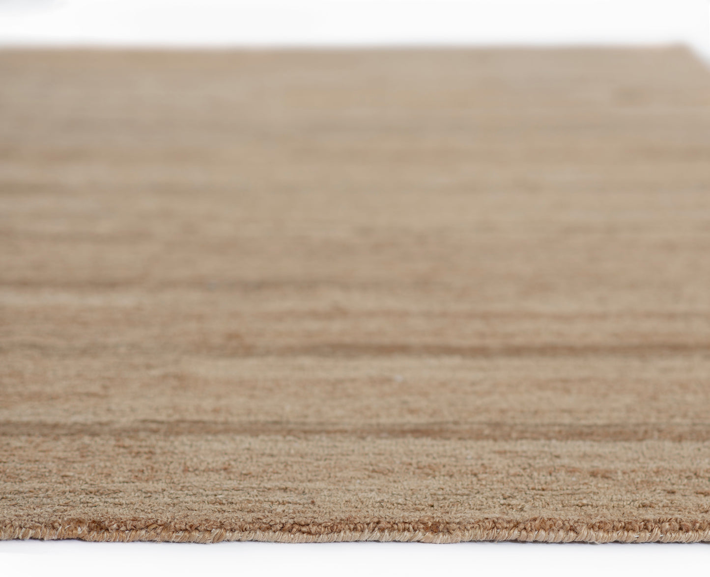 Natural beige jute rug with fringed edge, rectangular woven texture for living room or entryway.