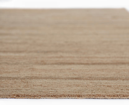 Natural beige jute rug with fringed edges, rectangular coastal-style floor mat.