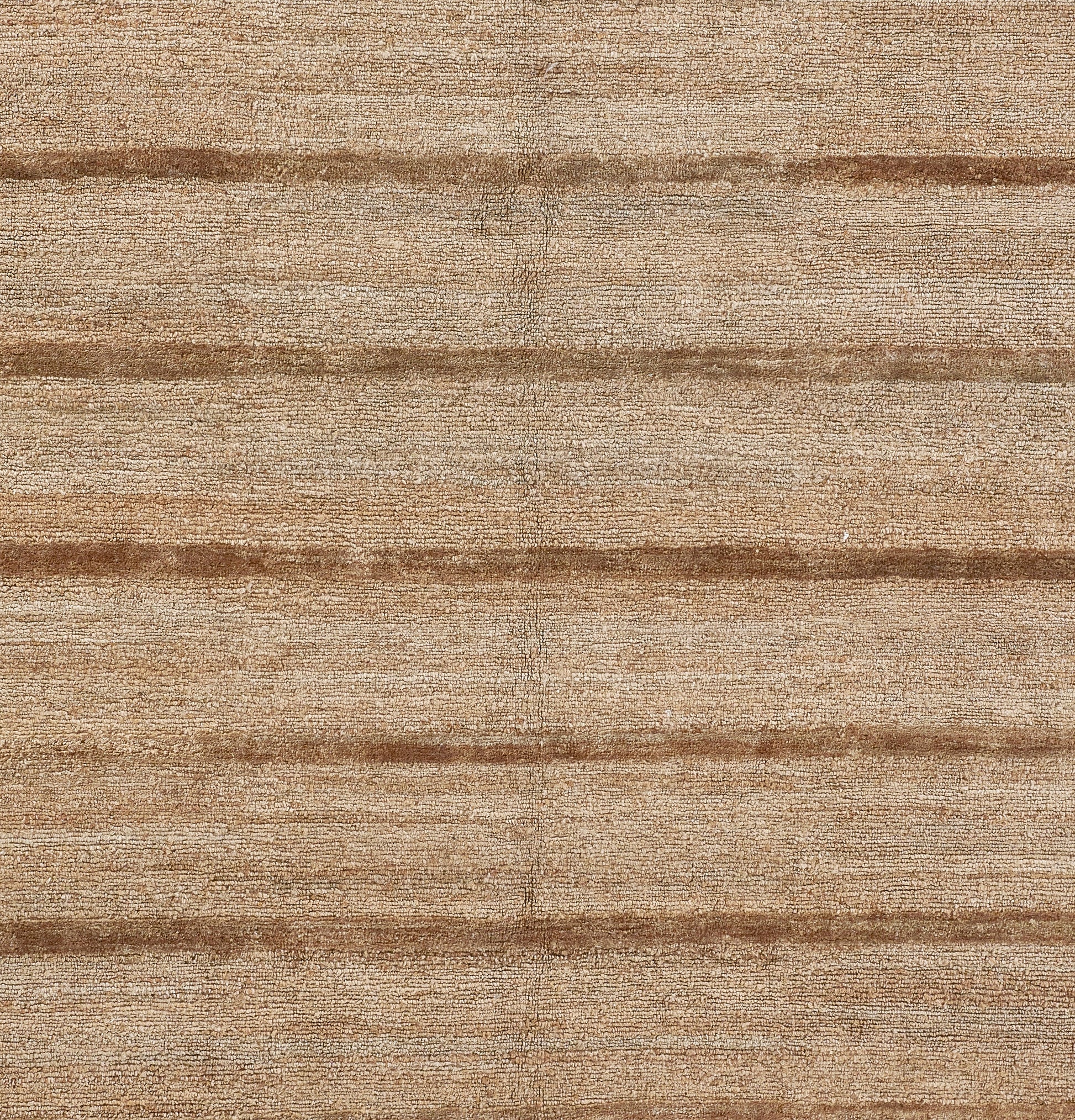 Natural beige-brown woven rug with dark horizontal stripes and textured surface.