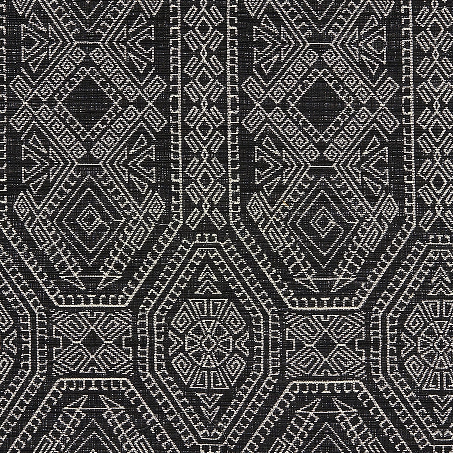 Black and white Navajo-inspired geometric pattern with diamonds and hex motifs on a woven Jacquard fabric.
