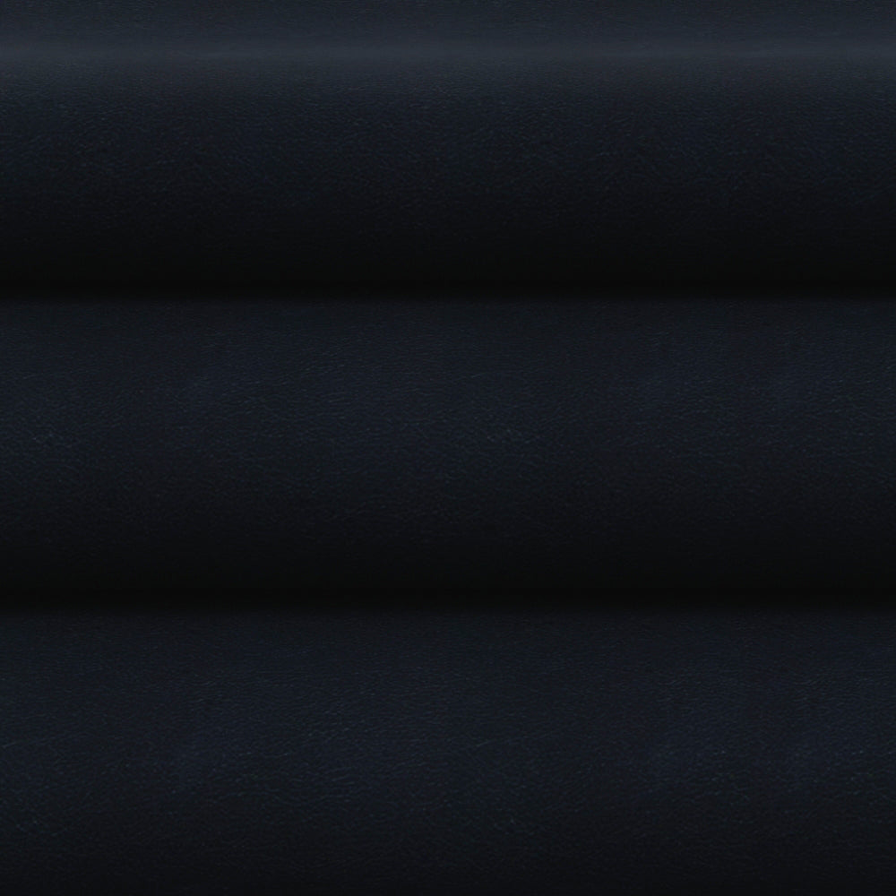 Dark navy faux leather fabric folded into horizontal layers, flat-lay presentation with smooth grain.