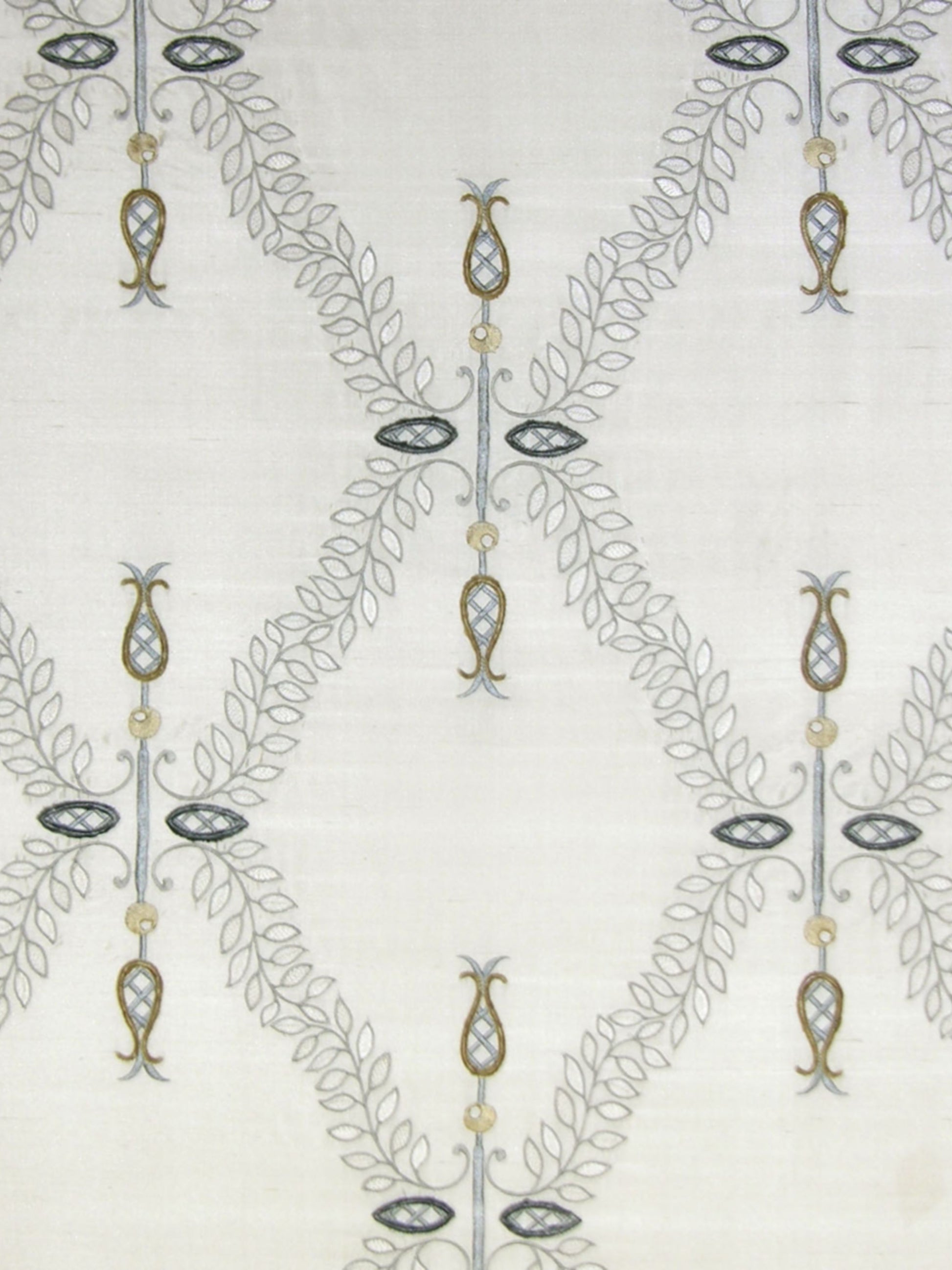 Light neutral linen-like fabric with repeating grey vine lattice forming diamonds; gold beads and navy oval pendants.