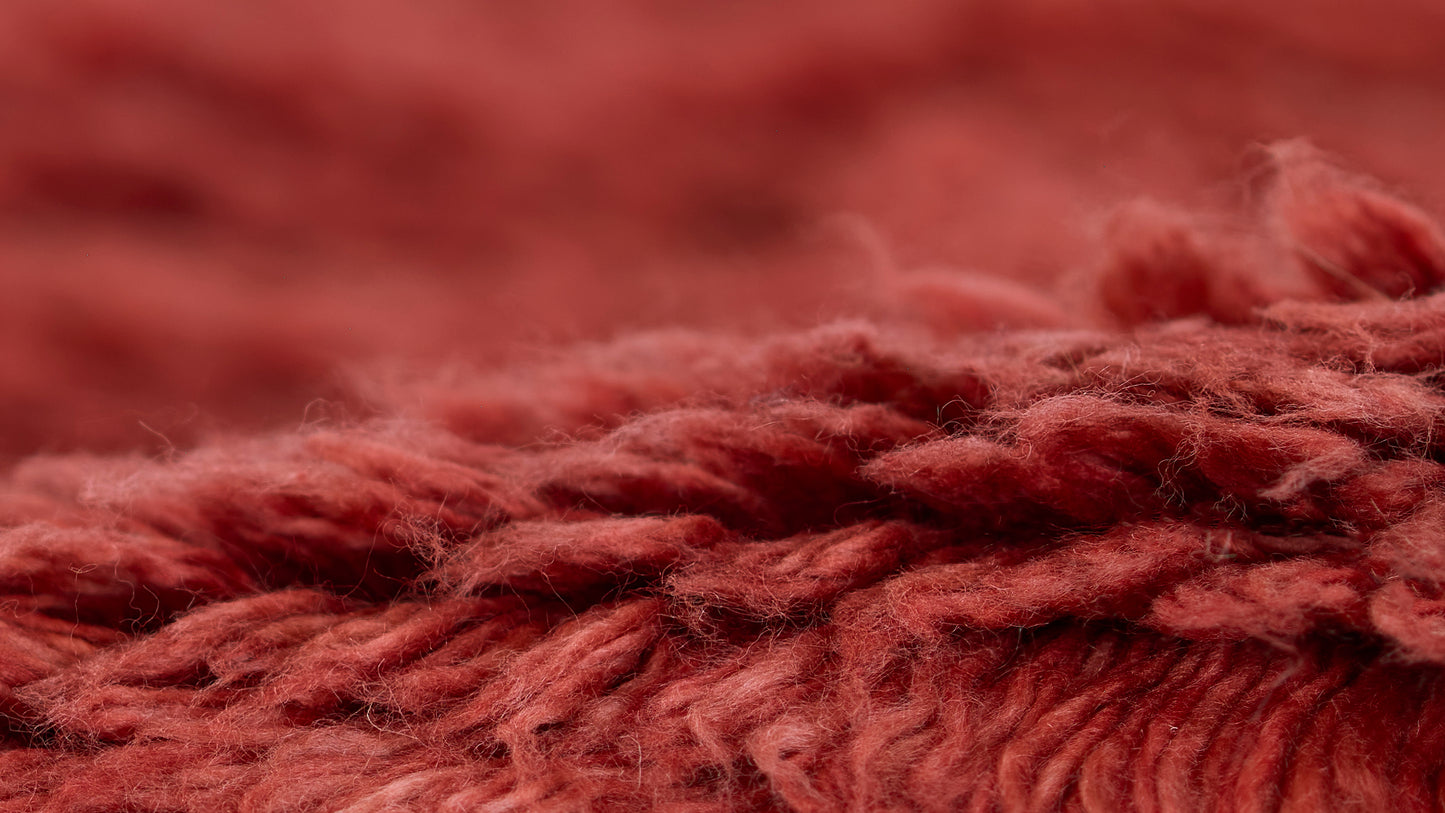 Close-up of red rug pile and fibers, plush and textured, 8' x 10' rug.