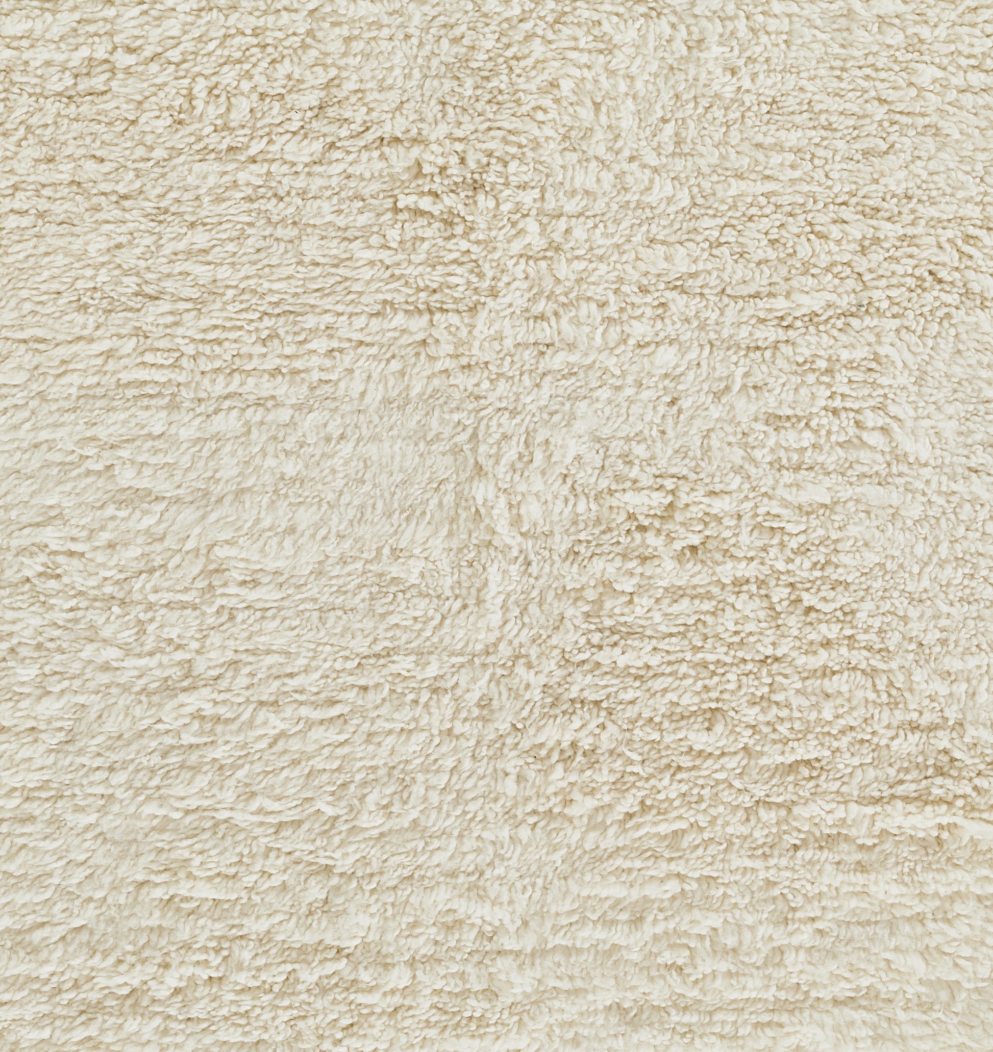 Ivory shag rug close-up with plush, textured pile.