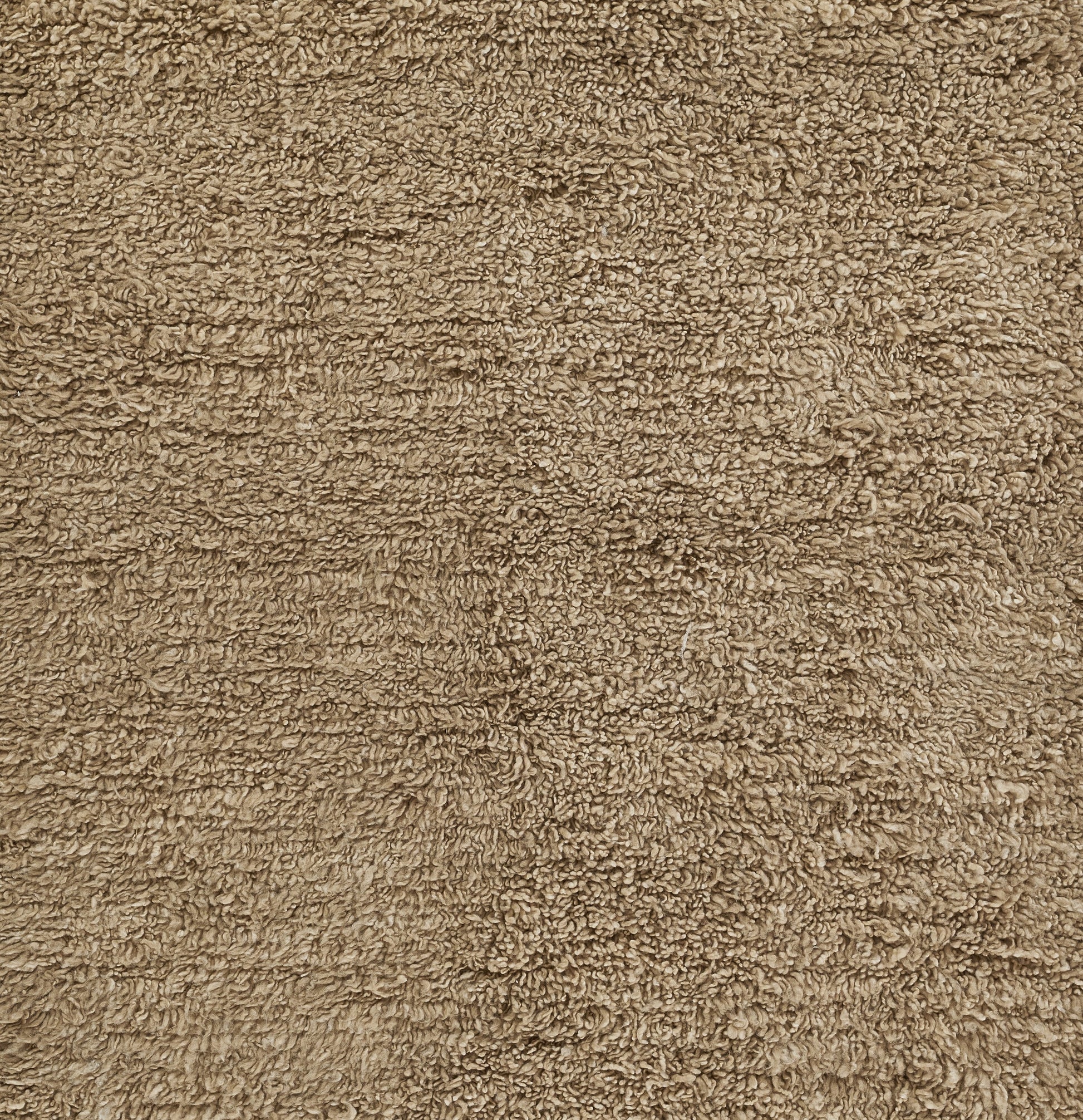 Tan-brown shag pile rug close-up; plush, soft texture in natural earthy tones for a cozy living space.