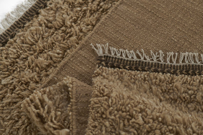Natural beige shag rug with plush pile, textured weave, and white fringe edging.