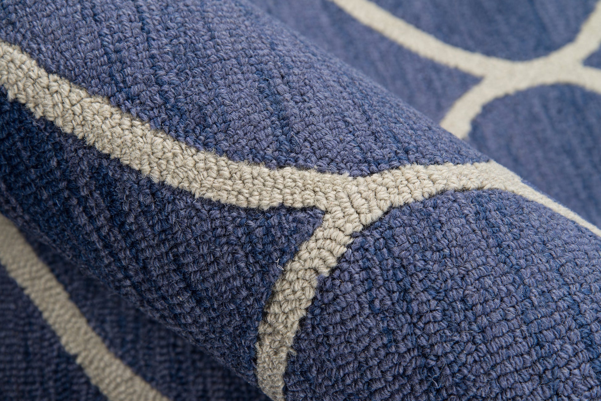 Navy blue terry fabric with cream geometric stripe pattern; plush loops, suitable as bath towel or decorative throw.