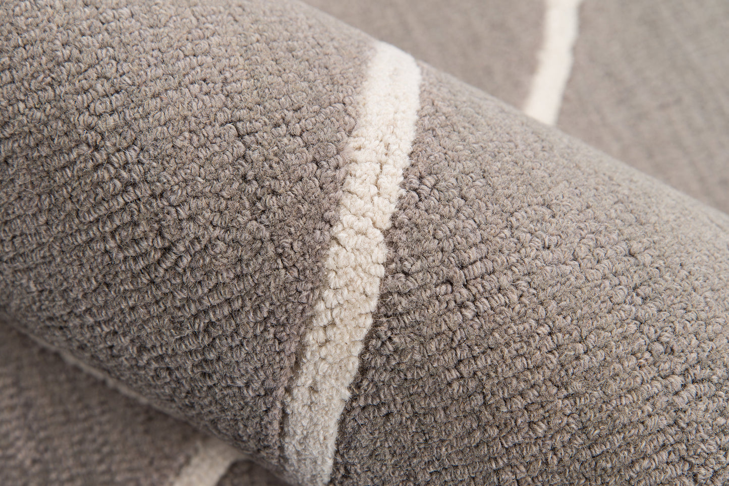 Close-up of gray plush terry rug fabric with a cream stripe.