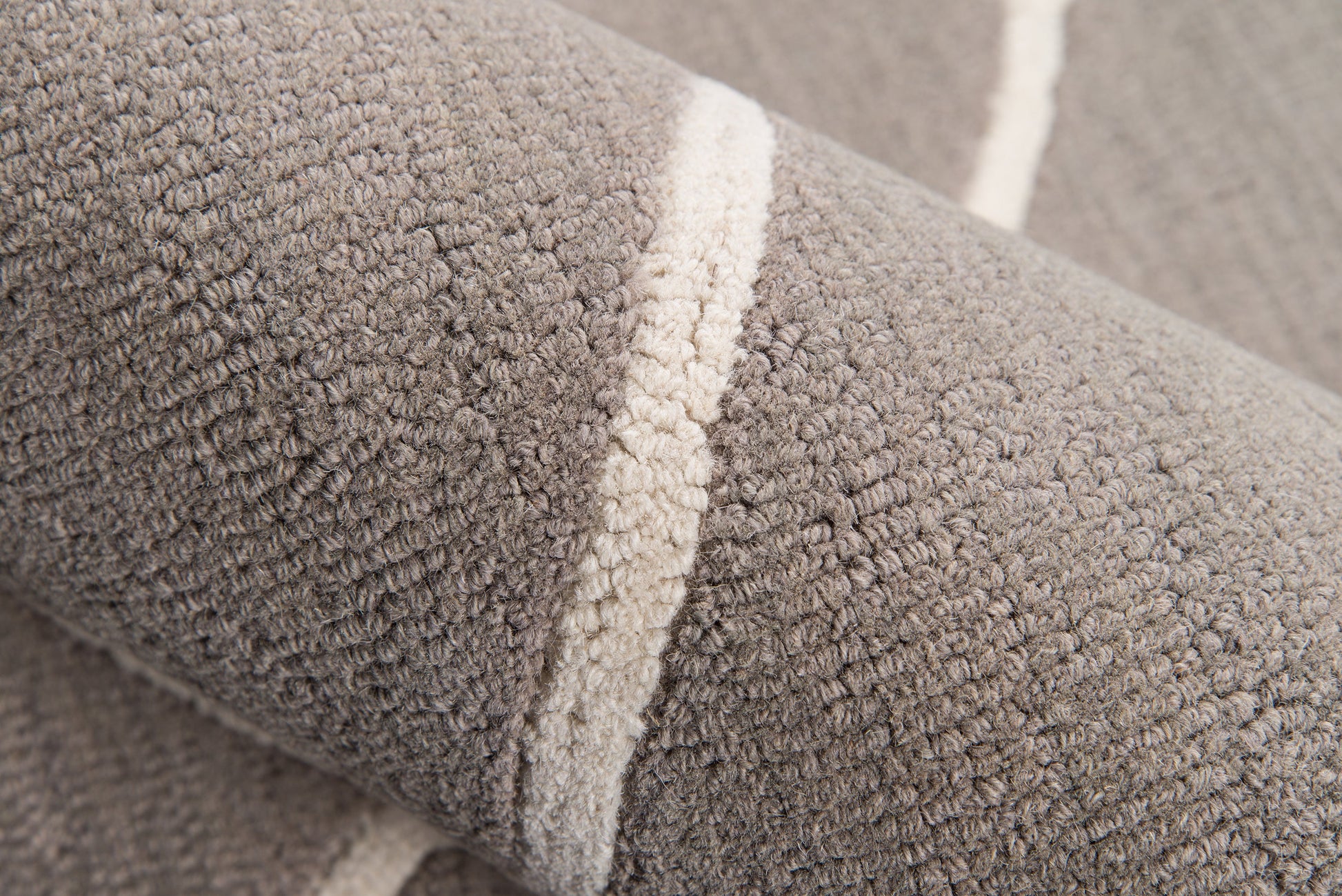 Close-up of gray plush terry rug fabric with a cream stripe.