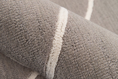 Close-up of gray plush terry rug fabric with a cream stripe.