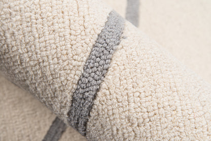 Cream sherpa fleece with a gray edge trim; plush, textured blanket or throw for cozy home decor.