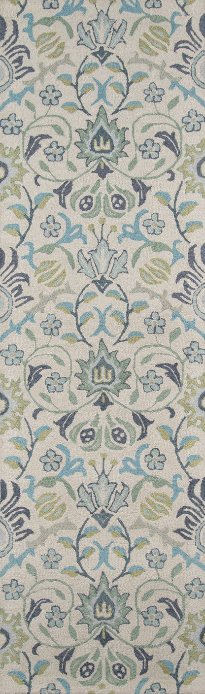 Woven damask floral rug in blue, green, and gray on a beige background.