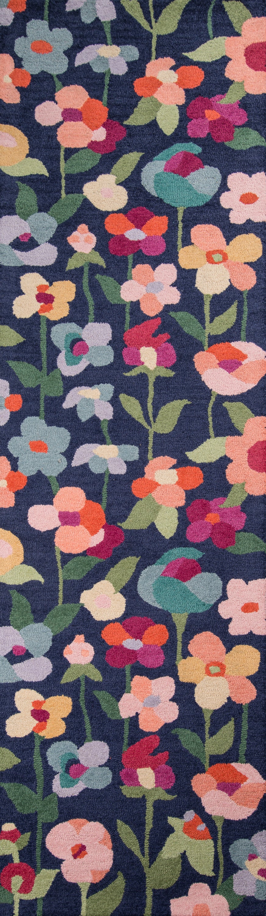 Navy blue floral rug with dense, colorful flowers in pinks, peaches, yellows, purples and greens.