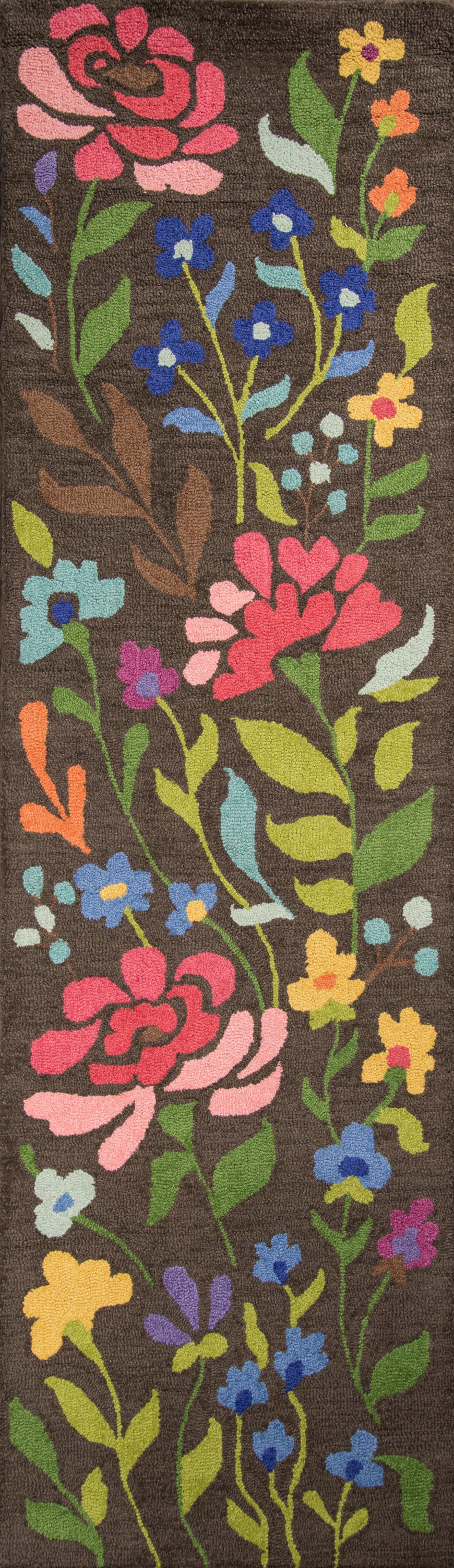 Brown floral rug with bright pink, blue, yellow & orange flowers and green leaves on a brown background.