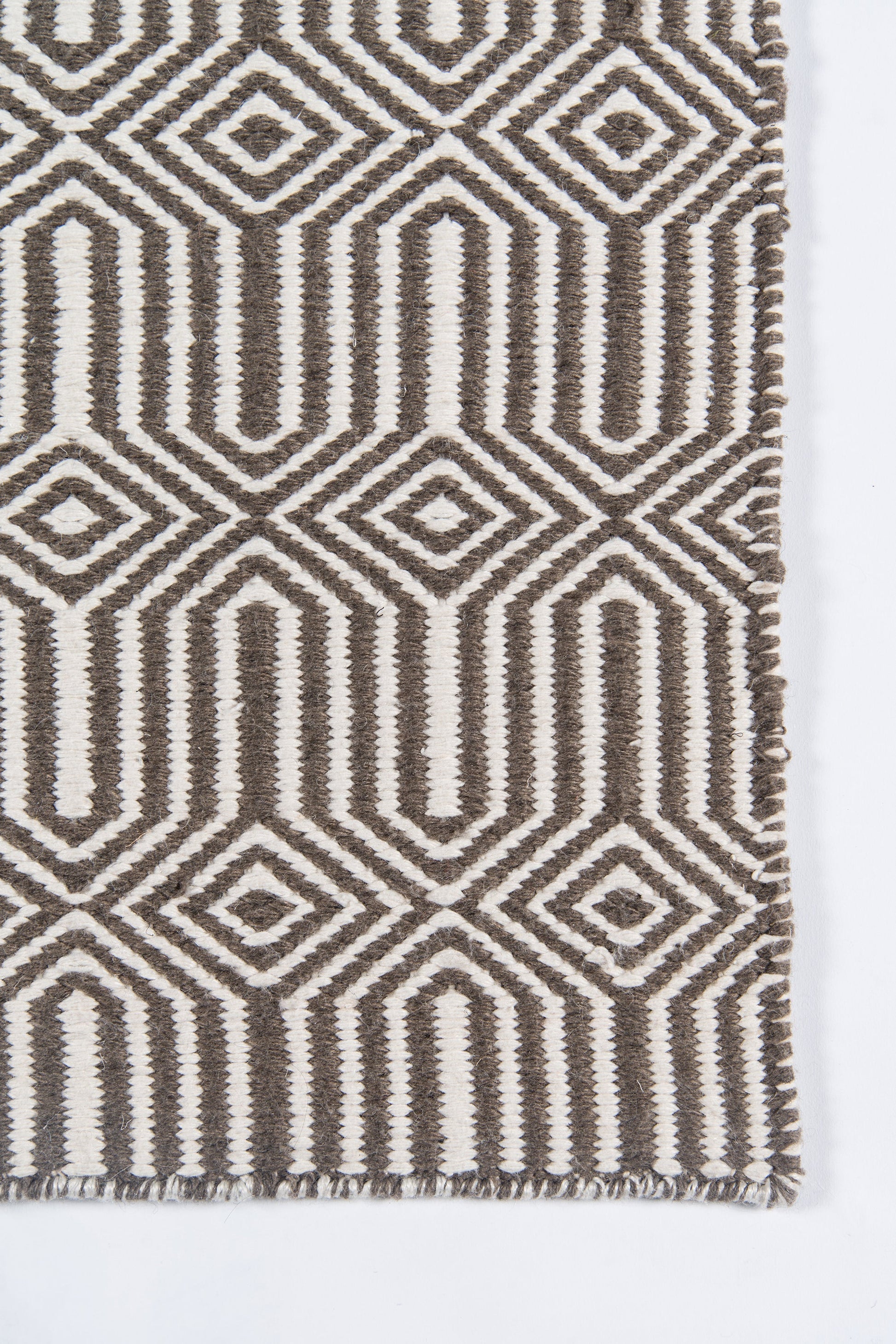 Brown and cream geometric woven rug with diamond motifs and fringe.
