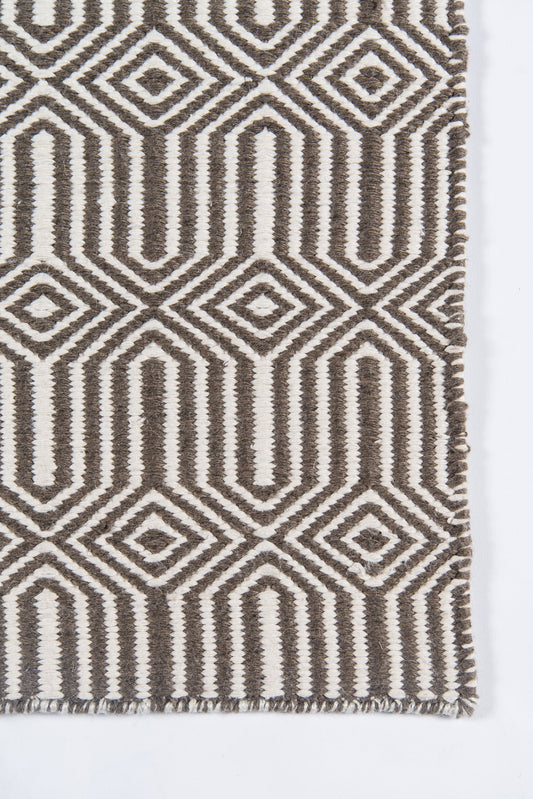 Brown and cream geometric woven rug with diamond motifs and fringe.