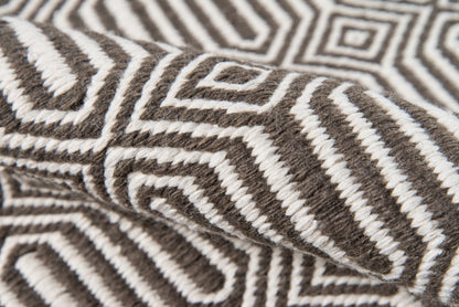 Brown & cream geometric knitted wool throw with bold maze pattern & chunky, soft texture.