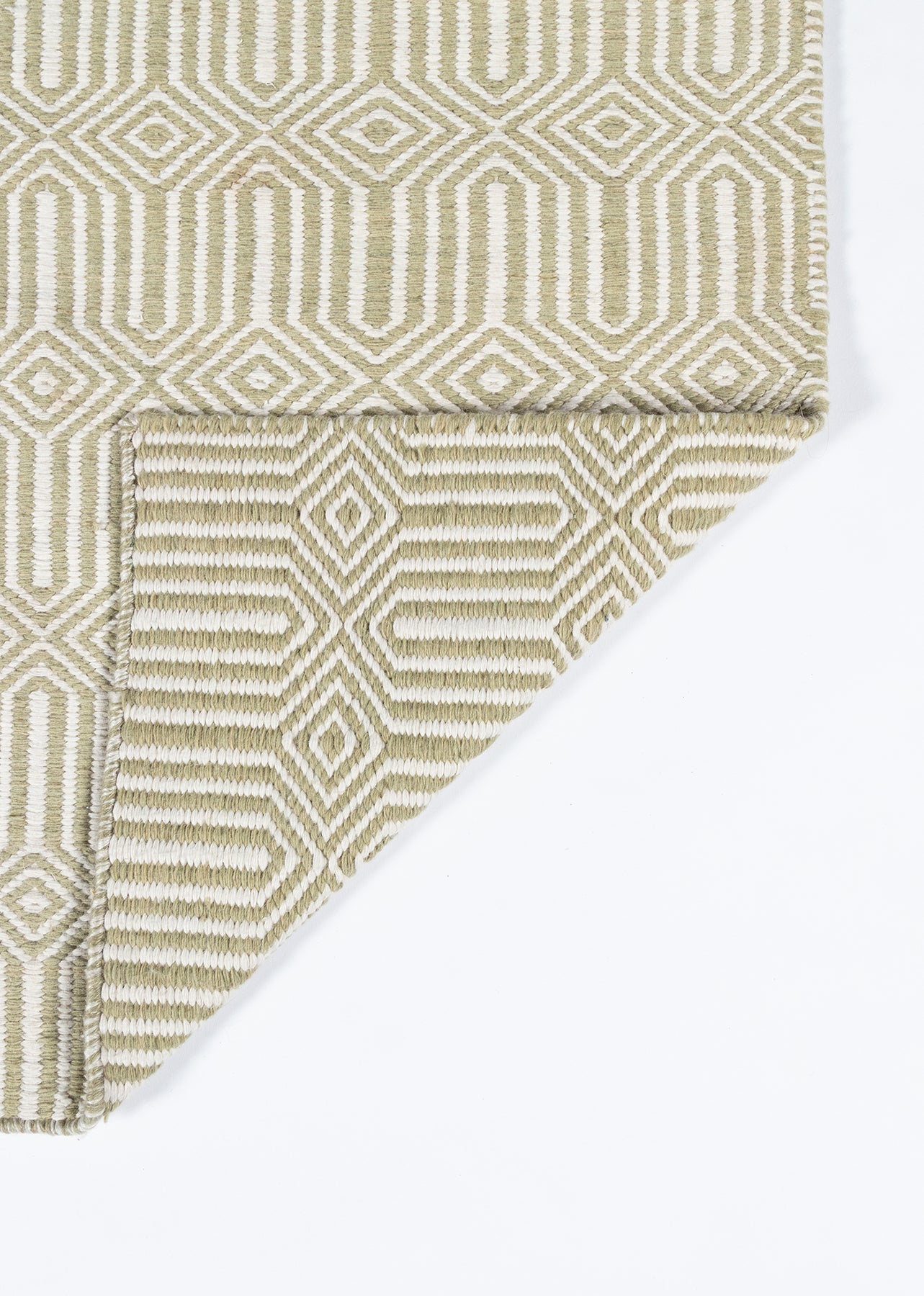 Beige & cream geometric woven rug with interlocking diamond pattern; folded corner reveals tight, textured weave.