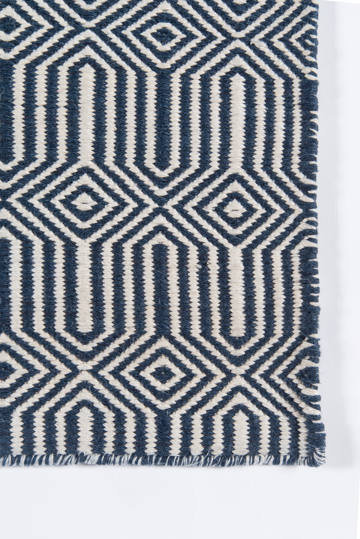 Navy blue & ivory geometric woven rug with diamond & arch motifs and fringed edge.