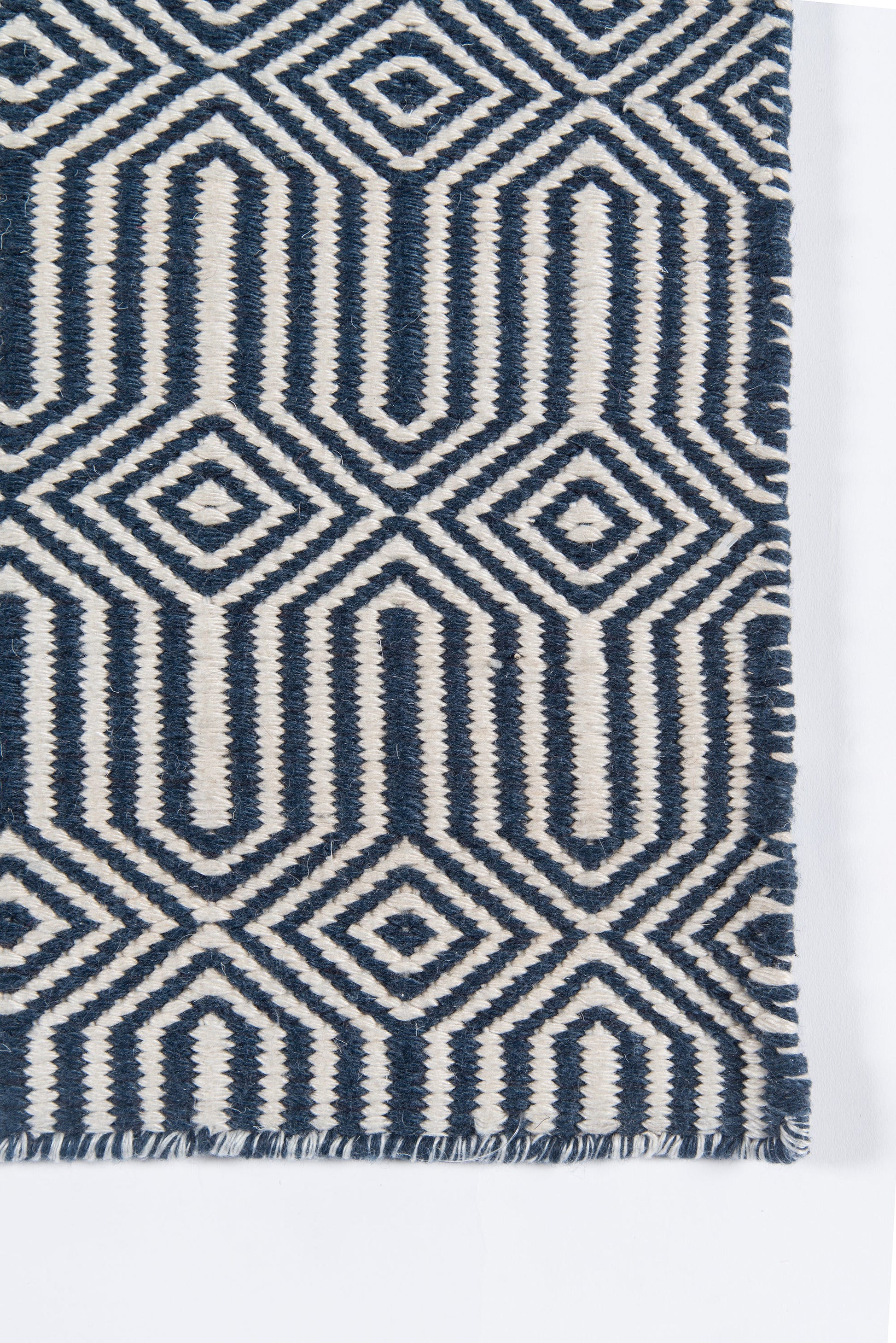 Navy blue & ivory geometric woven rug with diamond & arch motifs and fringed edge.
