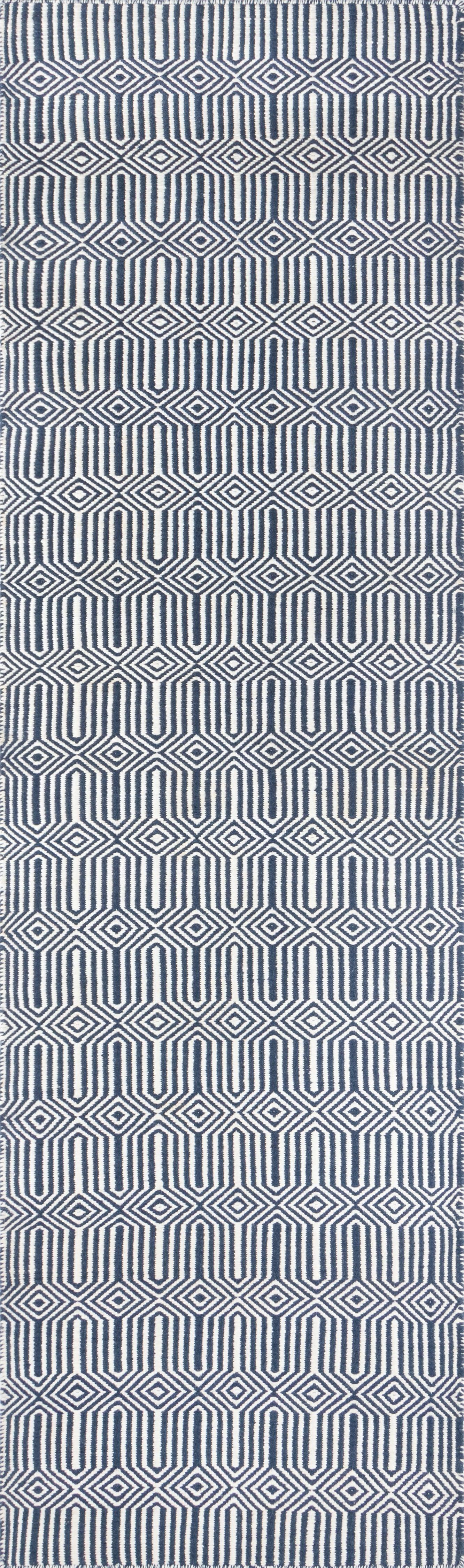 Navy and white geometric rug with diamond and U-shaped motifs; woven textile for modern living spaces.