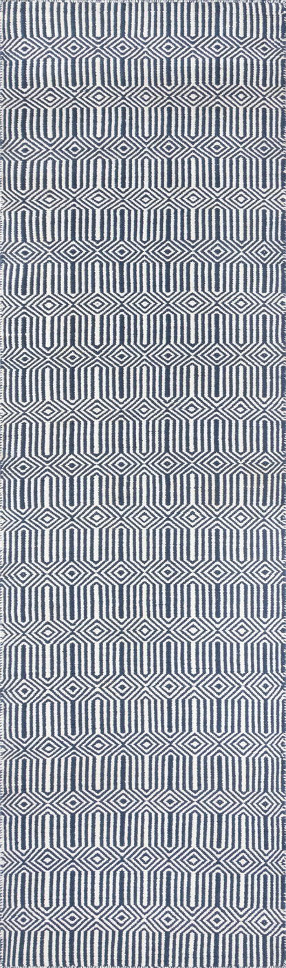 Navy and white geometric rug with diamond and U-shaped motifs; woven textile for modern living spaces.
