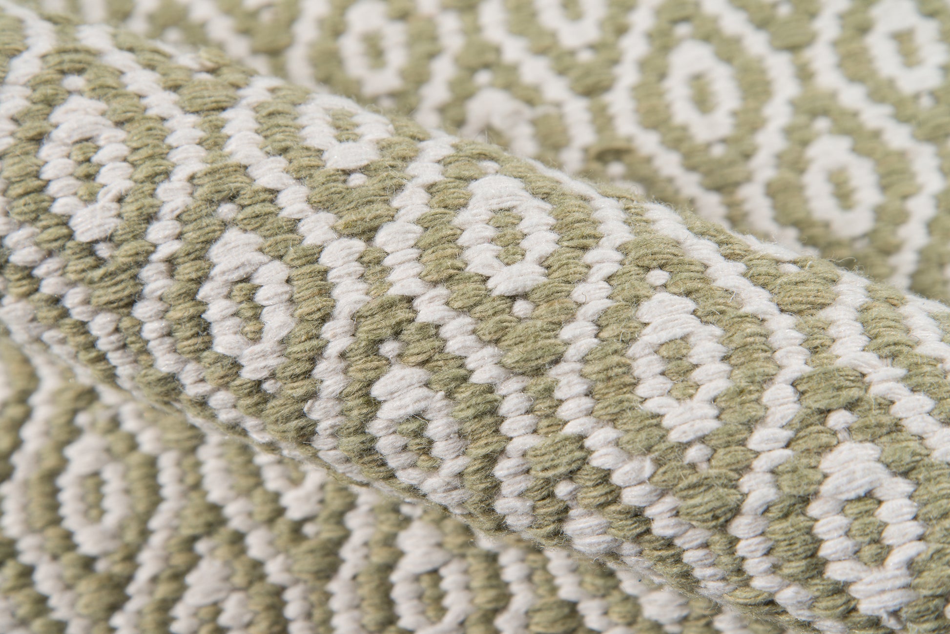 Olive green and ivory geometric wool rug with diamond motifs and thick woven texture, 5' x 8'.