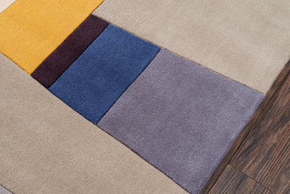 Modern patchwork rug runner with yellow, burgundy, blue, lavender & gray blocks on warm beige flooring.