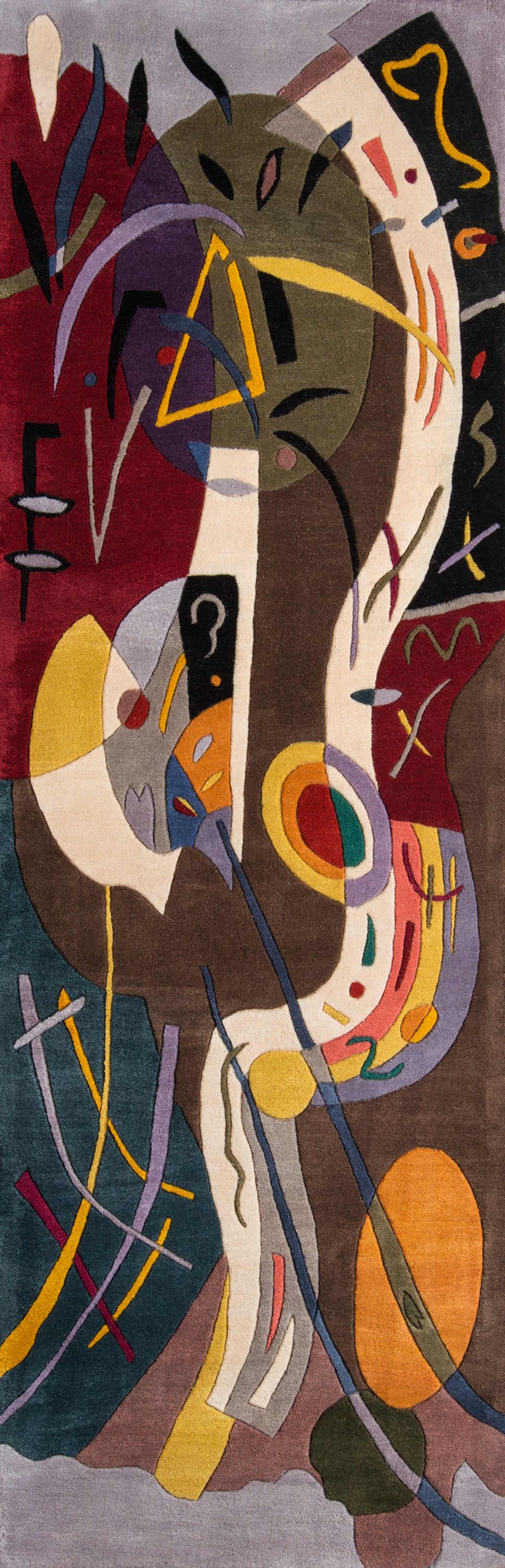Long rectangular abstract rug with bold geometric shapes and swirling lines in red, purple, yellow, brown and teal.