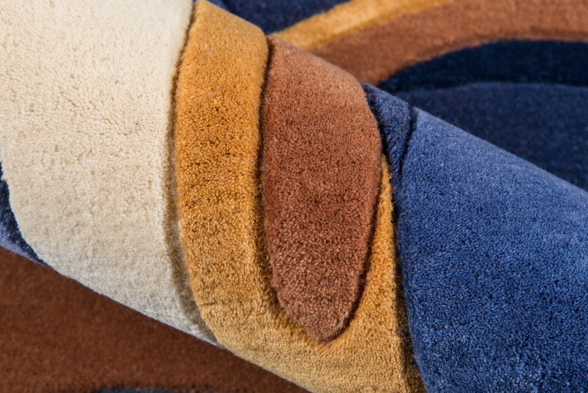 Color-block plush fleece blanket in beige, camel, brown and navy blue; soft, cozy throw.