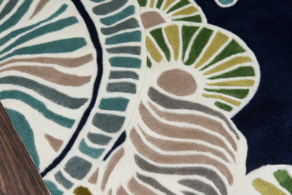 Navy rug with abstract botanical pattern in teal, green, beige and white.