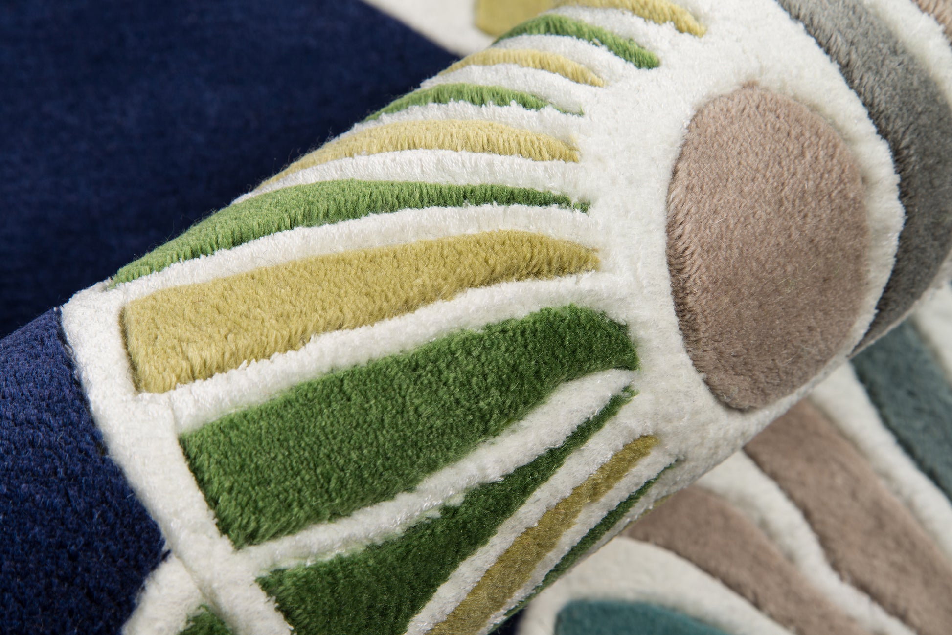 Soft plush rug with white base, green/yellow striped panels and beige circular accents; modern abstract pattern.