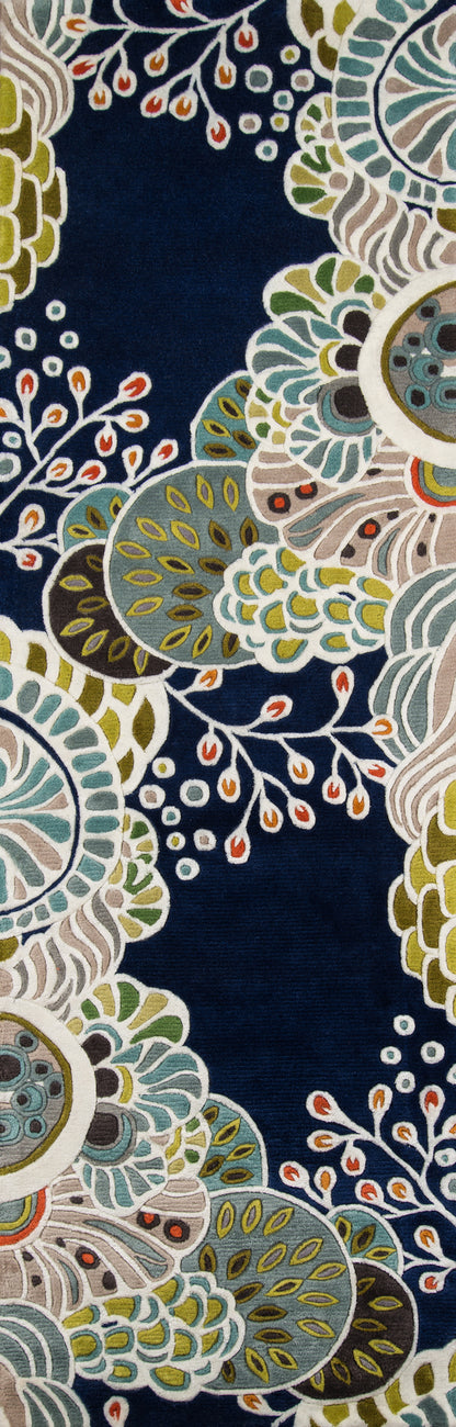 Navy round rug with bold multicolored floral mandala pattern in teal, green, yellow and cream.