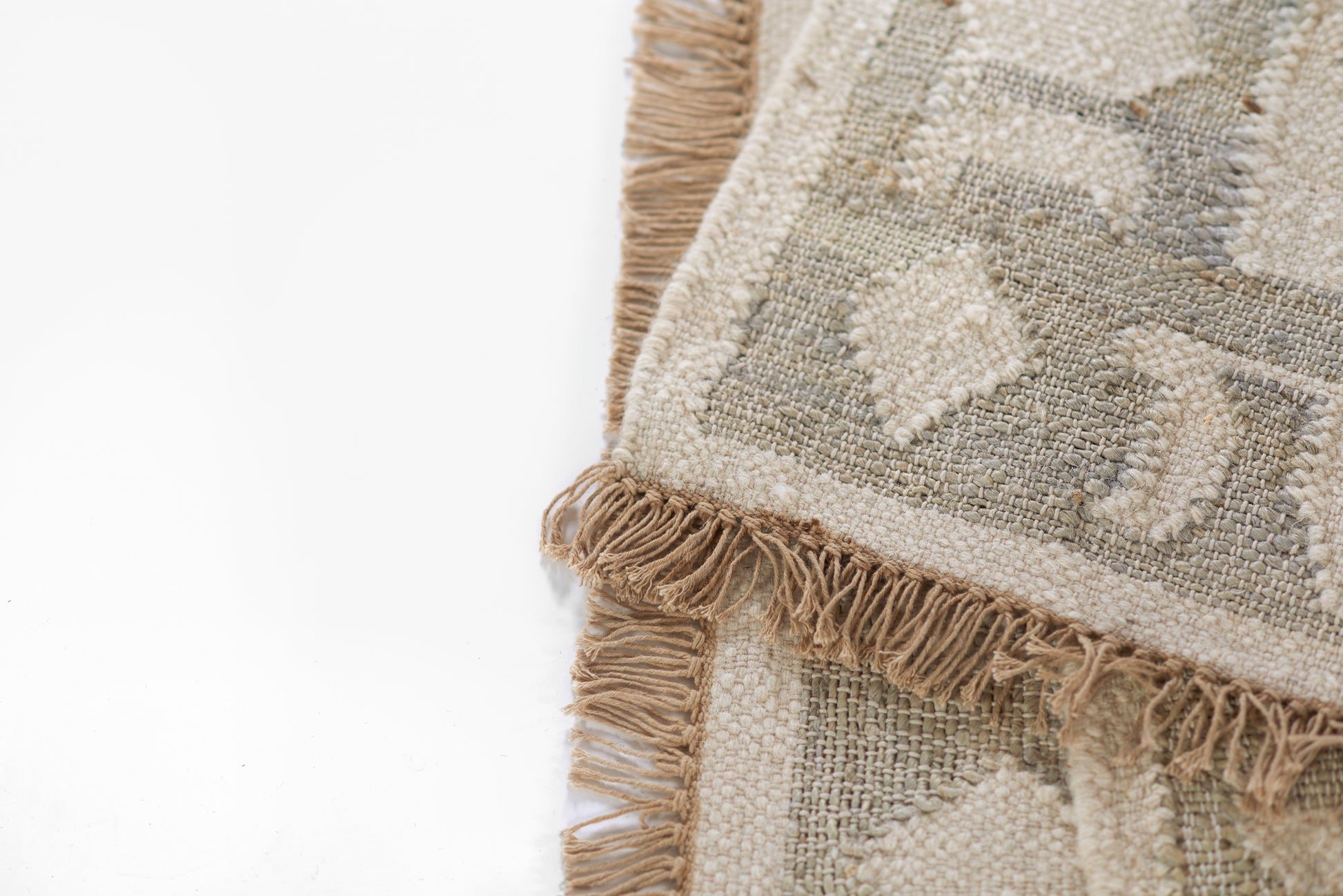 Blue-tinged beige geometric kilim rug with fringe edges and woven texture.