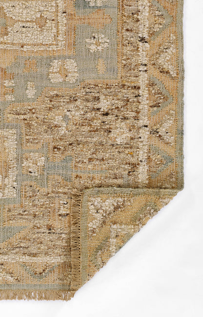 Beige and pale blue vintage oriental rug with floral motifs, woven texture and fringe edging.