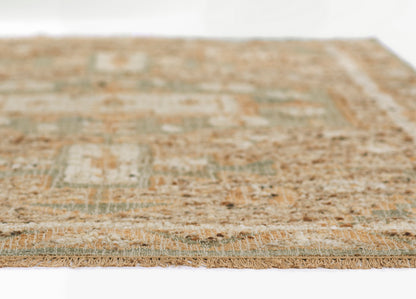 Rectangular patchwork flat-weave rug in beige, sage green & blue-gray with fringed edges.
