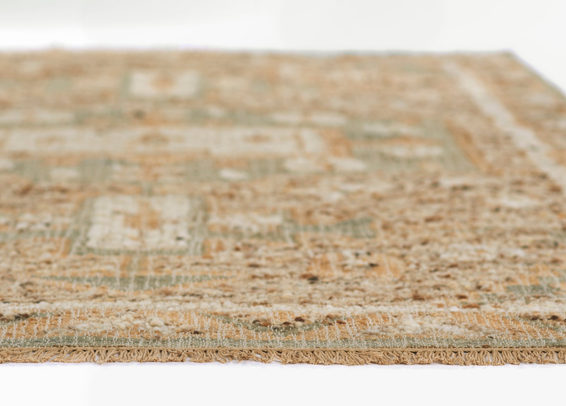 Rectangular vintage distressed rug in blue-teal and tan with fringe edge, geometric patchwork design.