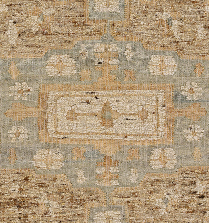 Muted blue-green vintage-style rug with ivory central medallion, tan floral border and distressed weave.