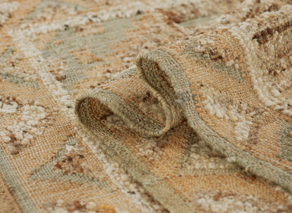 Soft woven rug in warm beige, tan, sage with ivory tufted accents and rolled edge.