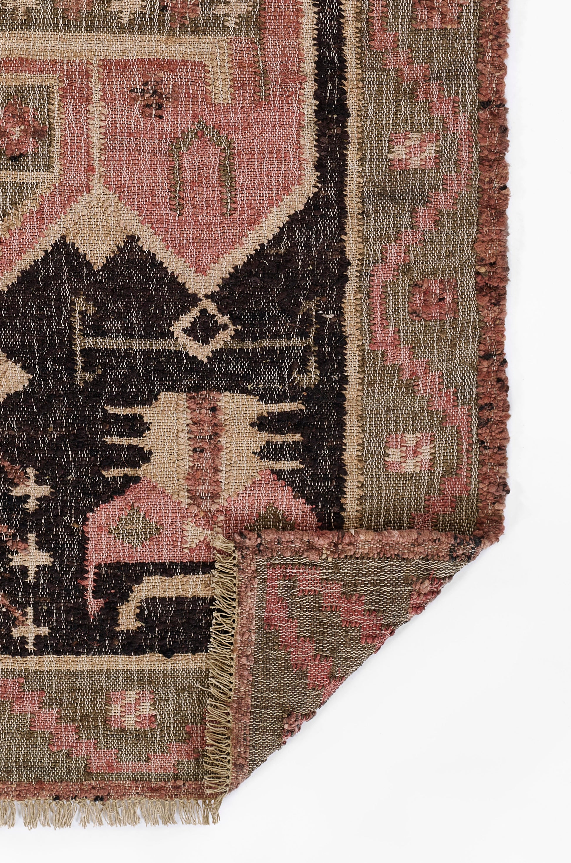 Handwoven oriental rug with pink, beige, olive, and dark brown geometric pattern; fringed edges.